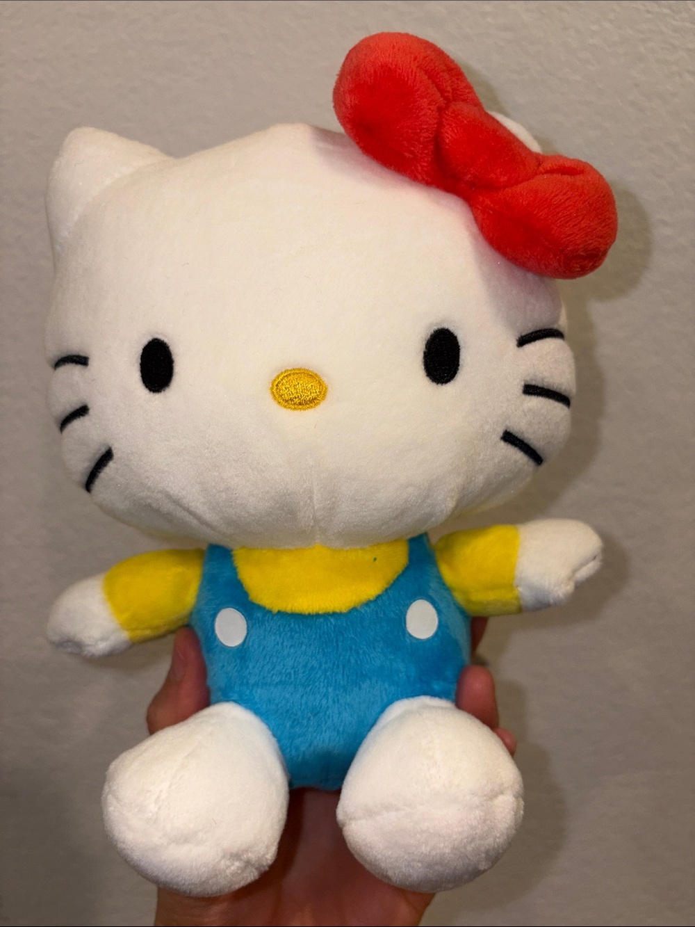 Hello Kitty Plush by Sanrio — White with Red Bow, Yellow Accents & Blue Outfit